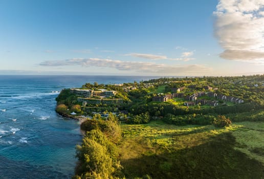 Aerial view of hotel and apartments on the headland in Princeville, Kauai seen from Hanalei Bay