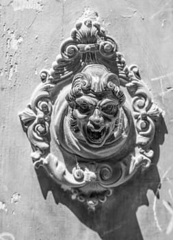 historic bell button at houses in Venice, symbolizing a shouting antiqoe man