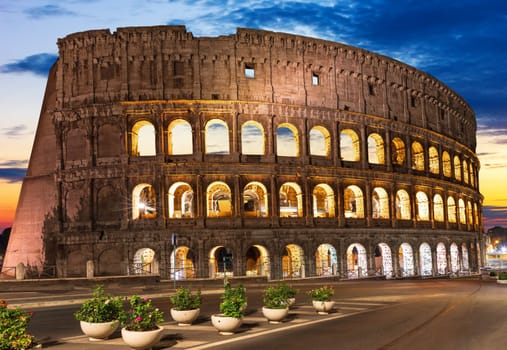 Roman Colosseum illuminated at sunset, Romw, Italy.
