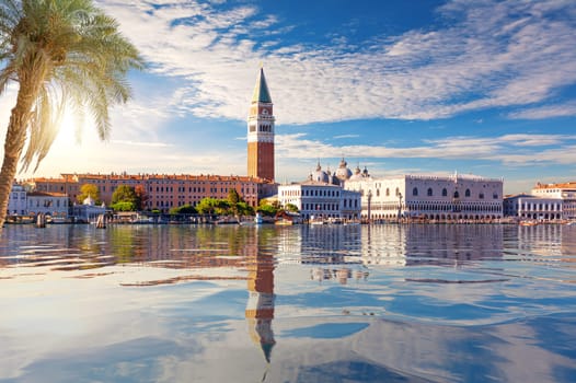 San Marco and Doge's Palace behind the palm, view from the lagoon of Venice, Italy.