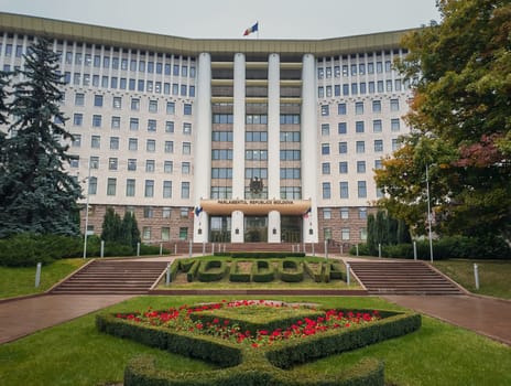 Republic of Moldova parliament building with beautiful garden. Rainy autumn day outdoors.