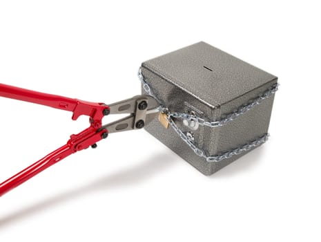 Cutting chain on safe with bolt cutters. Robbery concept.