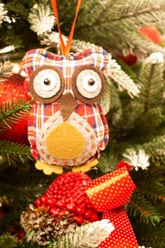 Close up view of cute Christmas tree decoration in form of owl figure. Christmas holidays concept. Vertical image