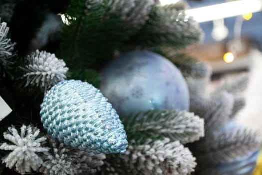 Christmas decoration with blue balls, tree branches and cones. Close up