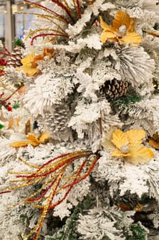 Christmas decoration. Golden, silver and white decor on Christmas tree branch. Stylish Christmas tree, vertical image