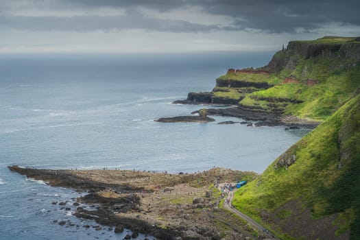 Crowds of tourists visiting Giants Causeway, seen from top of the cliff, Wild Atlantic Way and UNESCO world heritage, located in Northern Ireland