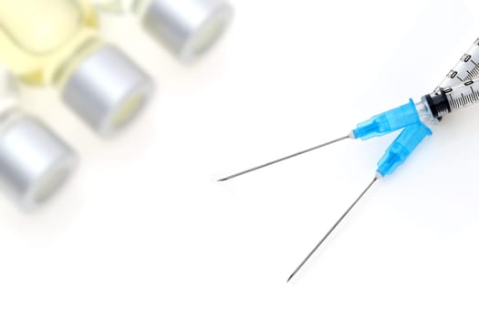 medical disposable syringe with vaccine bottle on white background