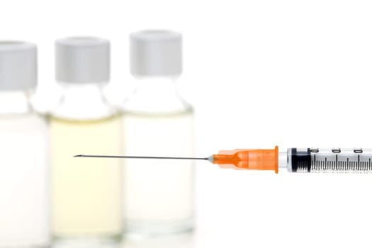medical disposable syringe with vaccine bottle on white background