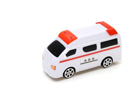 Japanese toy ambulance car isolated on white background, Translation: "Fire department"""