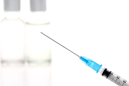 medical disposable syringe with vaccine bottle on white background