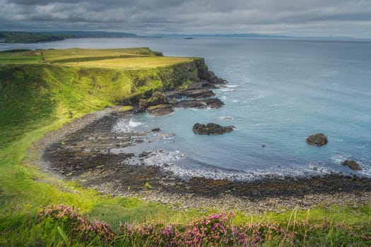 Giants Causeway bay with turquoise water, seen from top of the cliff, part of Wild Atlantic Way and UNESCO world heritage, located in Northern Ireland