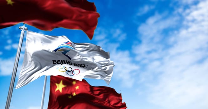 Beijing, China, October 2021: The flag of Beijing 2022 waving in the wind with the national flags of China. winter olympics games are scheduled to take place from 4 to 20 February 2022