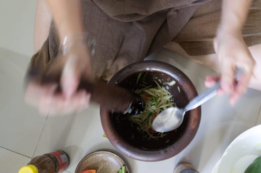 Motion Blur background , Som tum, making papaya salad in a mortar