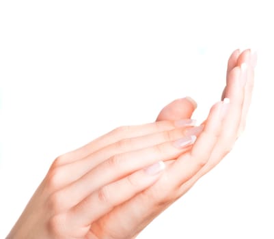 Beautiful female hands with french manicure isolated over white