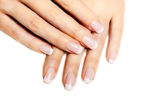 Beautiful female hands with french manicure isolated over white