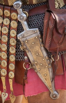Centurion girding a pugio, a dagger used by roman soldiers as a sidearm. Historical reenactment
