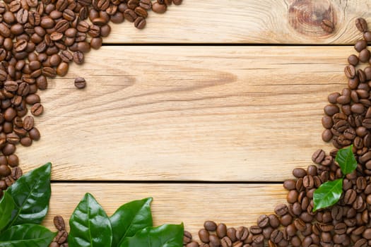 Coffee beans on wood background. Top view