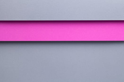 Abstract geometric composition background with gray and pink paper layers. Top view, flat lay