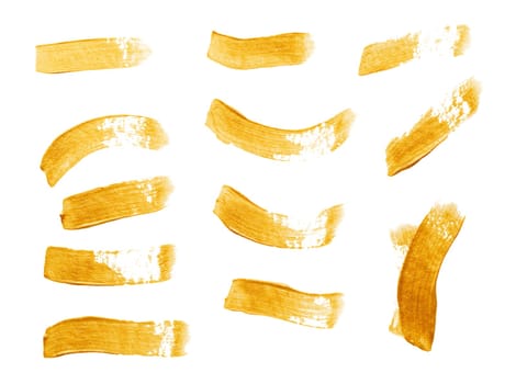 Set of golden paint strokes isolated on white background