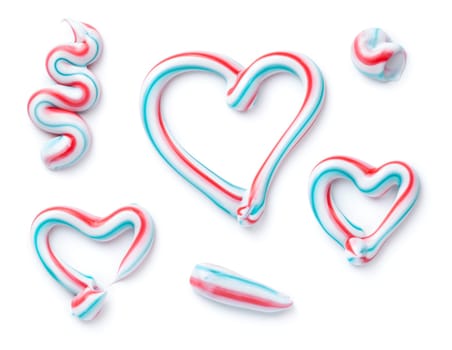 Three colored toothpaste sample set isolated over white background. Top view, flat lay