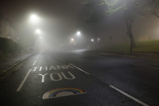 Sheffield, United Kingdom, 8th November, 2020: Thank you NHS rainbow painted on glossop road outside Hallamshire hospital in sheffield. Foggy night.