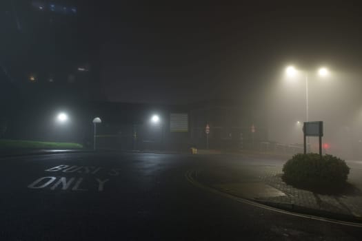 Sheffield, United Kingdom, 8th November, 2020: Bus turnaround point at Sheffield's Hallamshire hospital bus stop. Wide angle with thick fog at night.