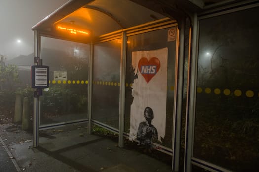 Sheffield, United Kingdom, 8th November, 2020: NHS Thank you appreciation poster partially torn down in a bus shelter, in the style of Banksy artwork
