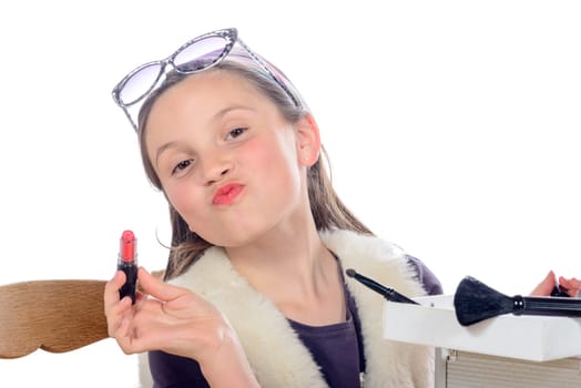 a little girl puts makeup of his mother on white