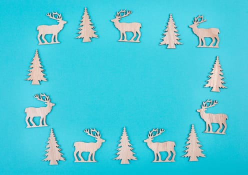 Reindeers, christmas trees, blue colored background, copy space for text, greeting card, winter backdrop