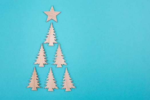 Christmas tree on a blue background, greeting card, festive background, copy space, wintertime, happy holidays