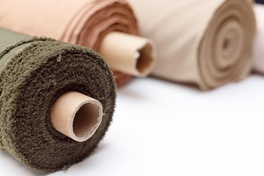 Rolls of pastel color fabric isolated on white, Synthetic and natural fabrics