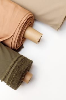 Rolls of pastel color fabric isolated on white, Synthetic and natural fabrics