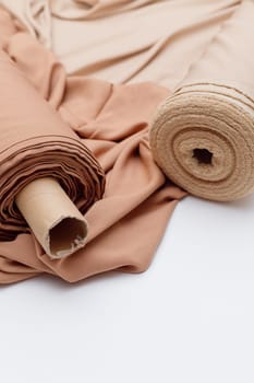 Rolls of pastel color fabric isolated on white, Synthetic and natural fabrics
