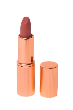Lipstick isolated. Closeup of a elegant gold red lipstick isolated on a white background. Make-up and beauty concept. Macro.