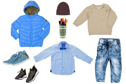 Collage set of little boy autumn clothing isolated on a white background. Denim trouser or pants, shoes, a rain jacket, pullover, shirt and a sweater for child boy. Kids spring and winter fashion.