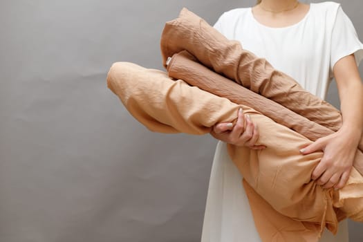 Business woman holding fabric rolls, working at textile shop