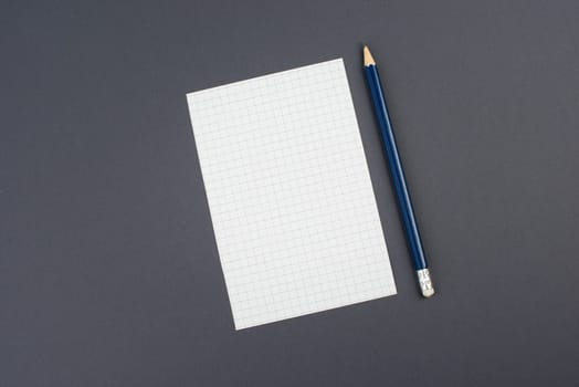 Empty paper with a pen on a dark grey background, copy space for text, busisness concept, education, minimalism