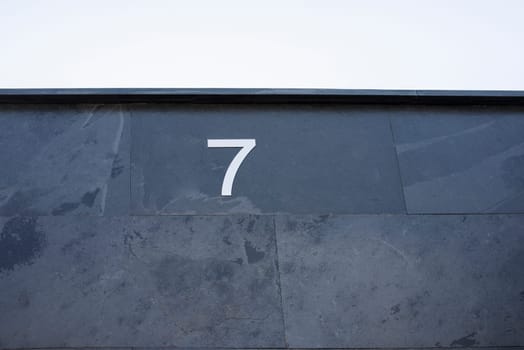 House number 7. Silver over black-blueish slate. Houses with personality concept