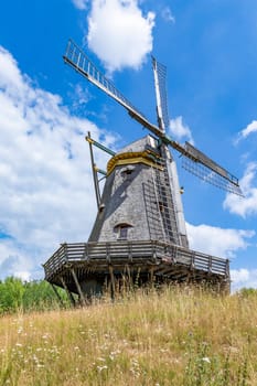 Windmill in rural landscape  in Germany, with blue and cloudy sky