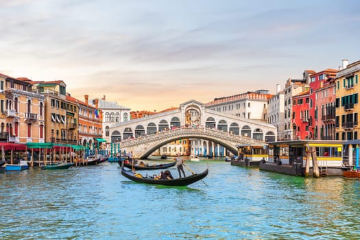 Rialto Bridge and gondoliers, a popular landmark of Venice, Italy.