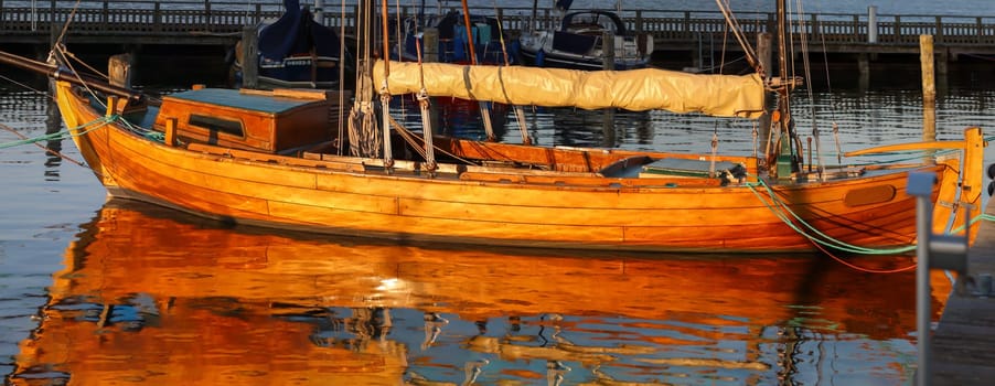 Details of a sailboat. A sailboat with a hull made of the finest machined wood.