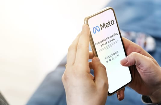 Menlo Park, CA, USA, October 28 2021: Woman holding a phone with the Meta mobile app on the screen. Meta is a technology company that will replace Facebook Inc.