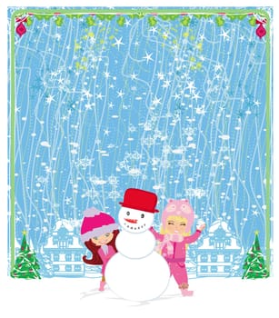 happy girls make a snowman on a beautiful winter's day