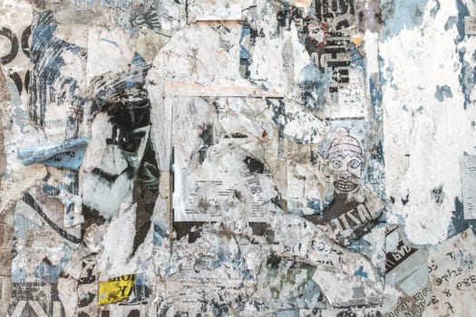 Grunge background with old torn posters. Multicolor texture.