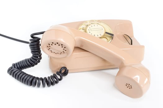 Vintage telephone. Pink old telephone isolated on white background.