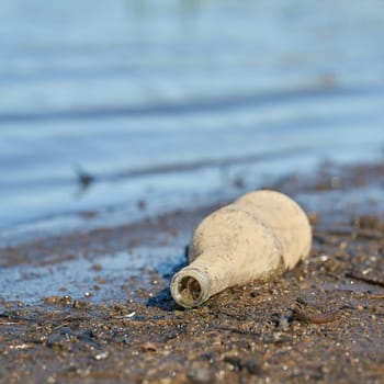 Bottle made of glass on the banks of the Elbe in Herrenkrug Park near Magdeburg