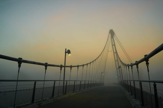 The Herrenkrugsteg, a suspension bridge over the river Elbe on the Elbe cycle path near Magdeburg in the fog