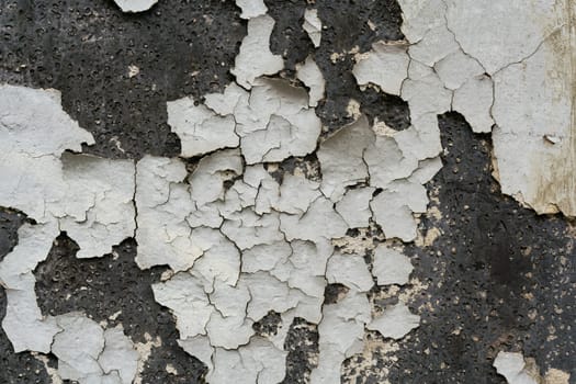 peeled white paint on the facade of an old house in Berlin