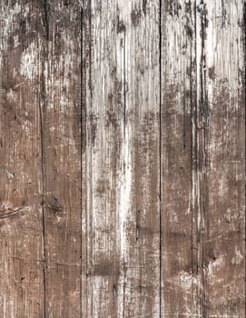 Vertical wooden planks. Close- up of a wall made of old wooden planks.