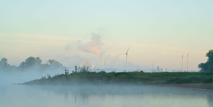Industrial area Rothensee at the bank of the river Elbe at fog seen from Herrenkrugpark